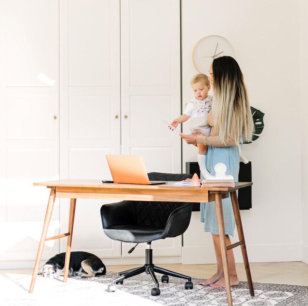 work-from-home mama and baby in minimalist office